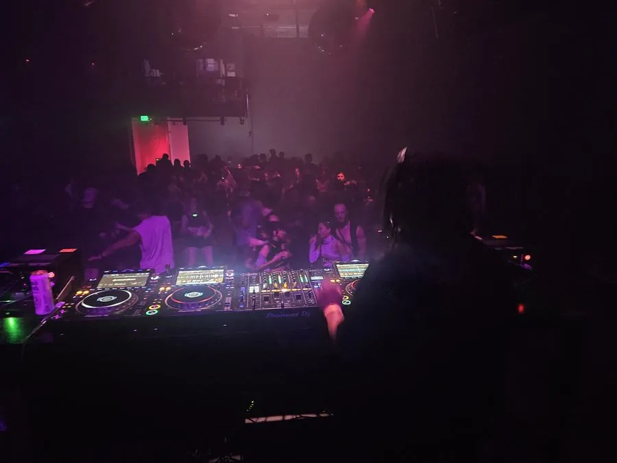 Quentin Hiatus DJing over a packed dance floor