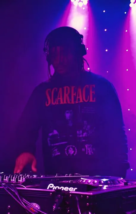 Quentin Hiatus DJing under pink and purple stage lights